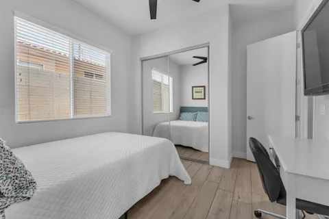 a bedroom with a bed a window and a chandelier