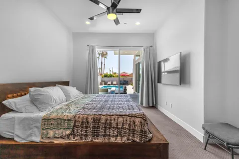 a bedroom with a large bed and a chandelier