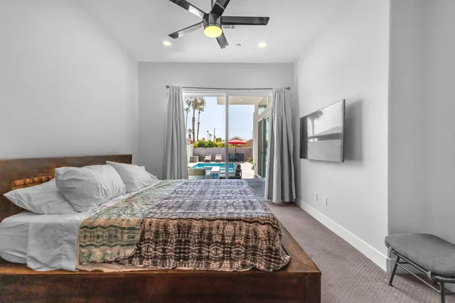 a bedroom with a large bed and a chandelier