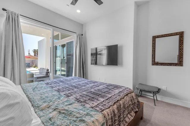 a bed sitting in a bedroom next to a window