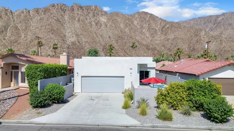 an aerial view of a house with a yard and potted plants