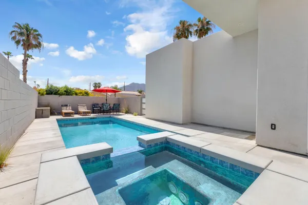 a backyard of a house with table and chairs