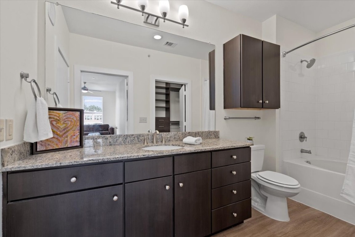 1900 Barton Springs Road, Unit 5001 Austin, TX 78704 - Photo 18 of 34 a bathroom with a granite countertop toilet sink and mirror