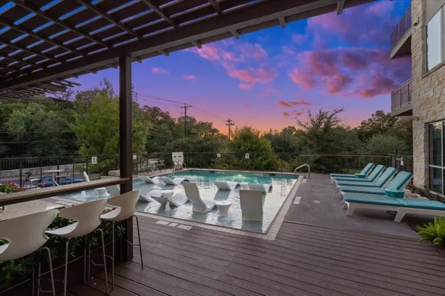 a view of a swimming pool with outdoor seating