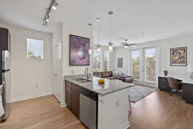 a view of a kitchen area with sink and wooden floor