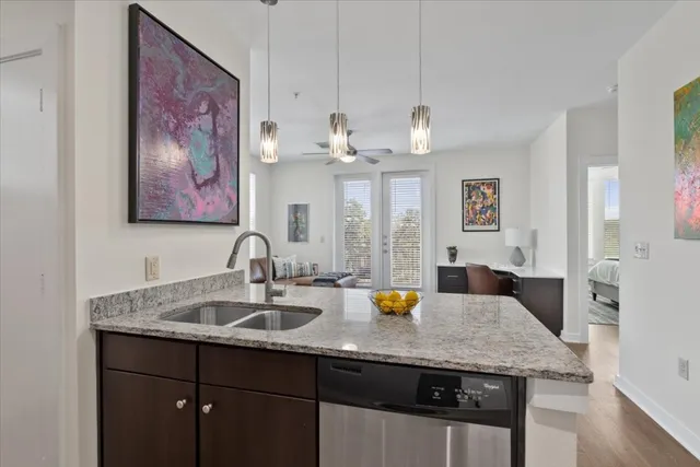 a kitchen with a refrigerator and wooden floor
