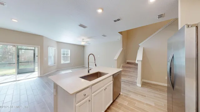 a kitchen with sink cabinets and wooden floor
