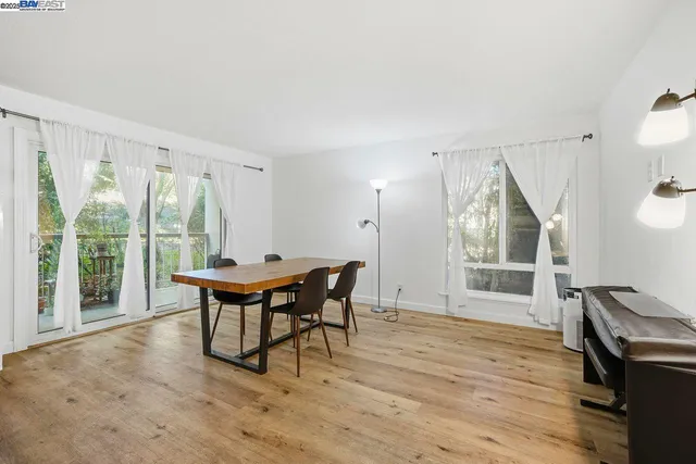 a dining room with furniture and wooden floor