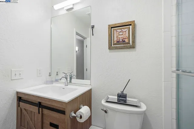 a bathroom with a sink a mirror and vanity