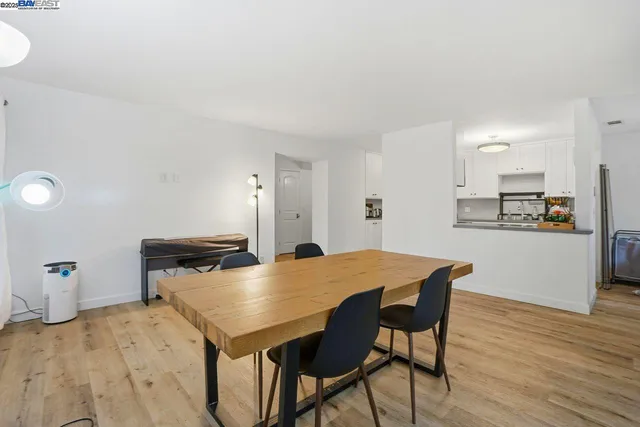 a living room with dining room and wooden floor