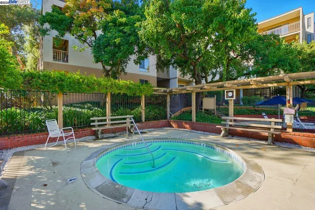 a swimming pool with outdoor seating and yard