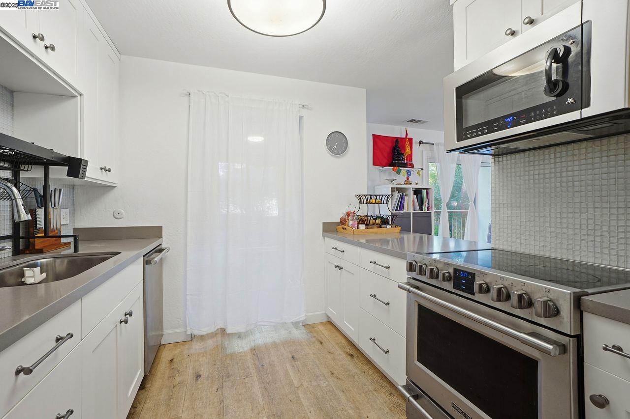 310 North Civic Drive, Unit 102 Walnut Creek, CA 94596 - Photo 34 of 39 a kitchen with a stove and a microwave