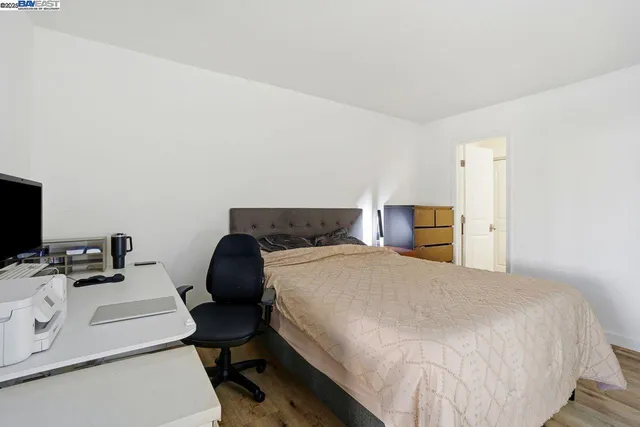 a bedroom with a bed and a chair