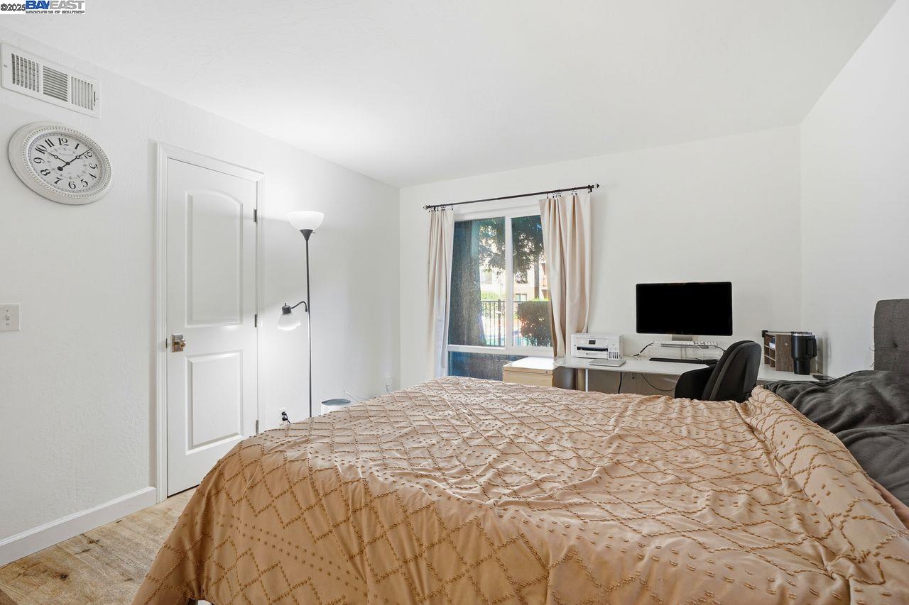 310 North Civic Drive, Unit 102 Walnut Creek, CA 94596 - Photo 7 of 39 a bedroom with a bed and a flat screen tv