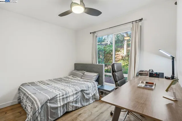 a bedroom with a bed and a desk