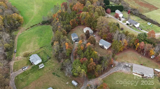an aerial view of a house a yard and a wooden bridge