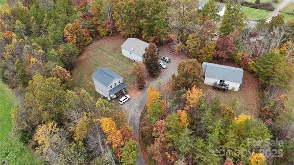 an aerial view of a house with yard and parking space