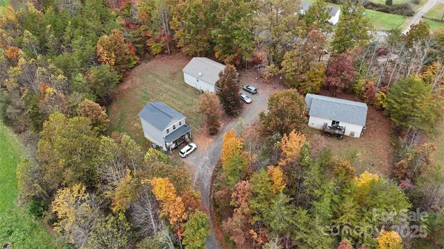 an aerial view of a house with yard and parking space