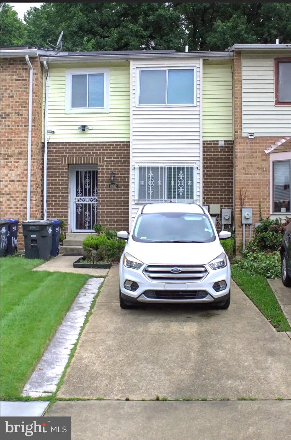 1902 Valley Terrace Southeast Washington, DC 20032 - Photo 1 of 33 a front view of a house with a garden