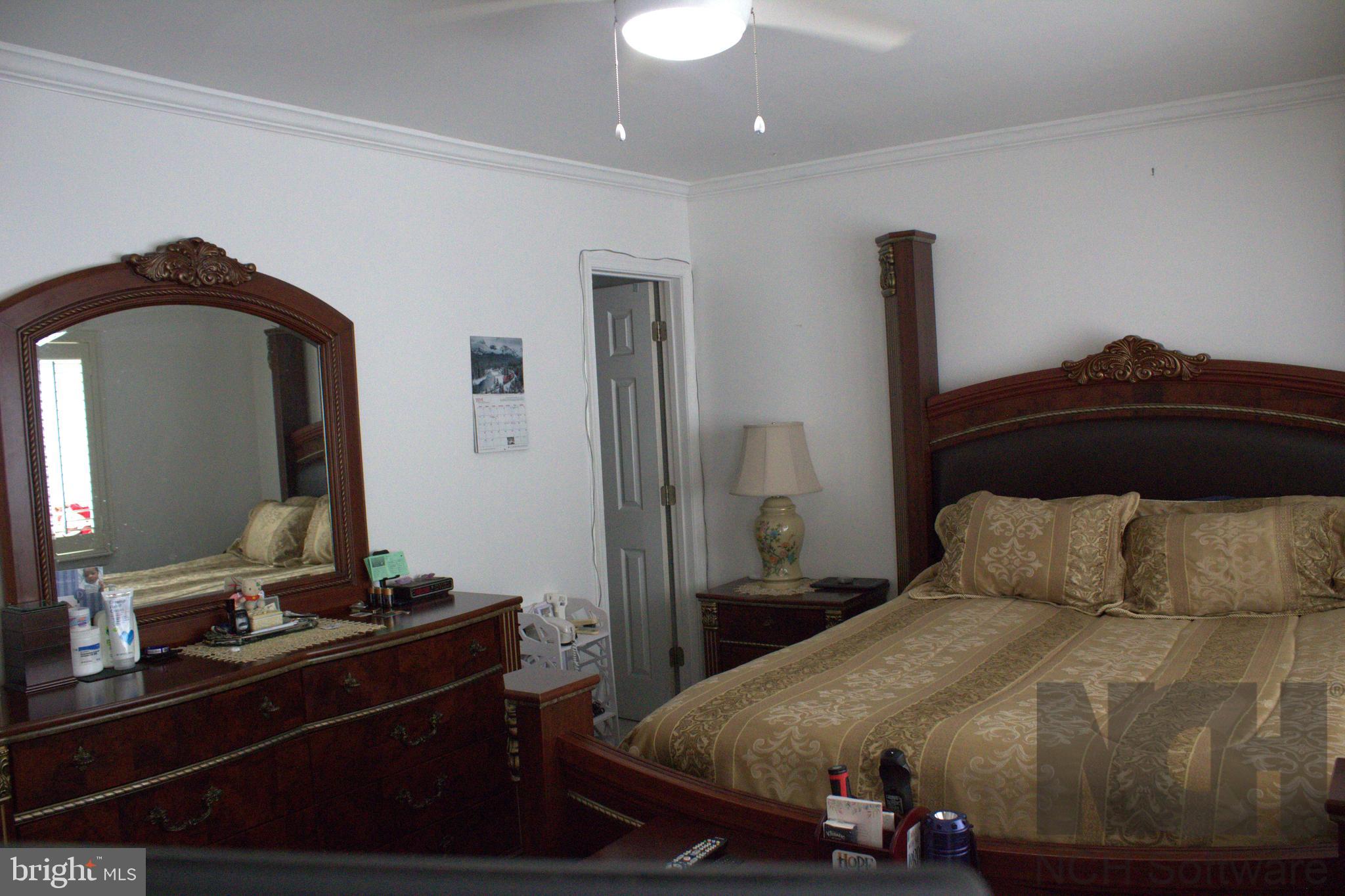 1902 Valley Terrace Southeast Washington, DC 20032 - Photo 12 of 33 a bedroom with a bed and a mirror