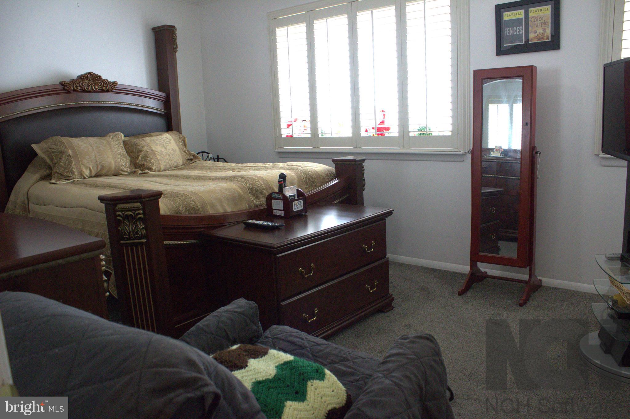 1902 Valley Terrace Southeast Washington, DC 20032 - Photo 13 of 33 a bedroom with a bed and window