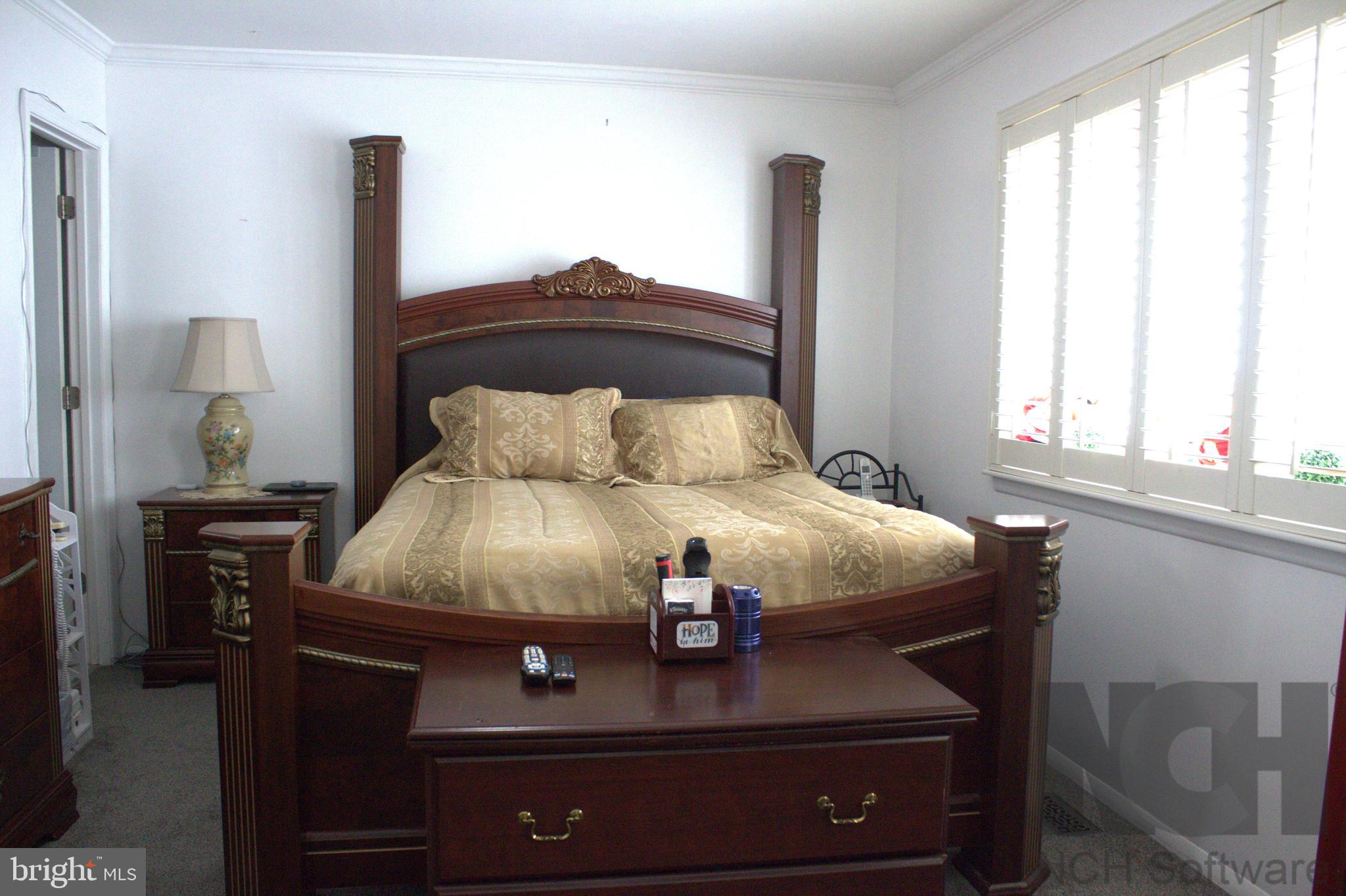 1902 Valley Terrace Southeast Washington, DC 20032 - Photo 14 of 33 a bed sitting in a bedroom next to a window
