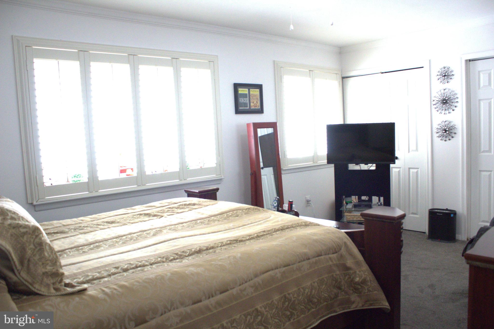 1902 Valley Terrace Southeast Washington, DC 20032 - Photo 15 of 33 a bedroom with a bed and a flat tv screen on a dresser
