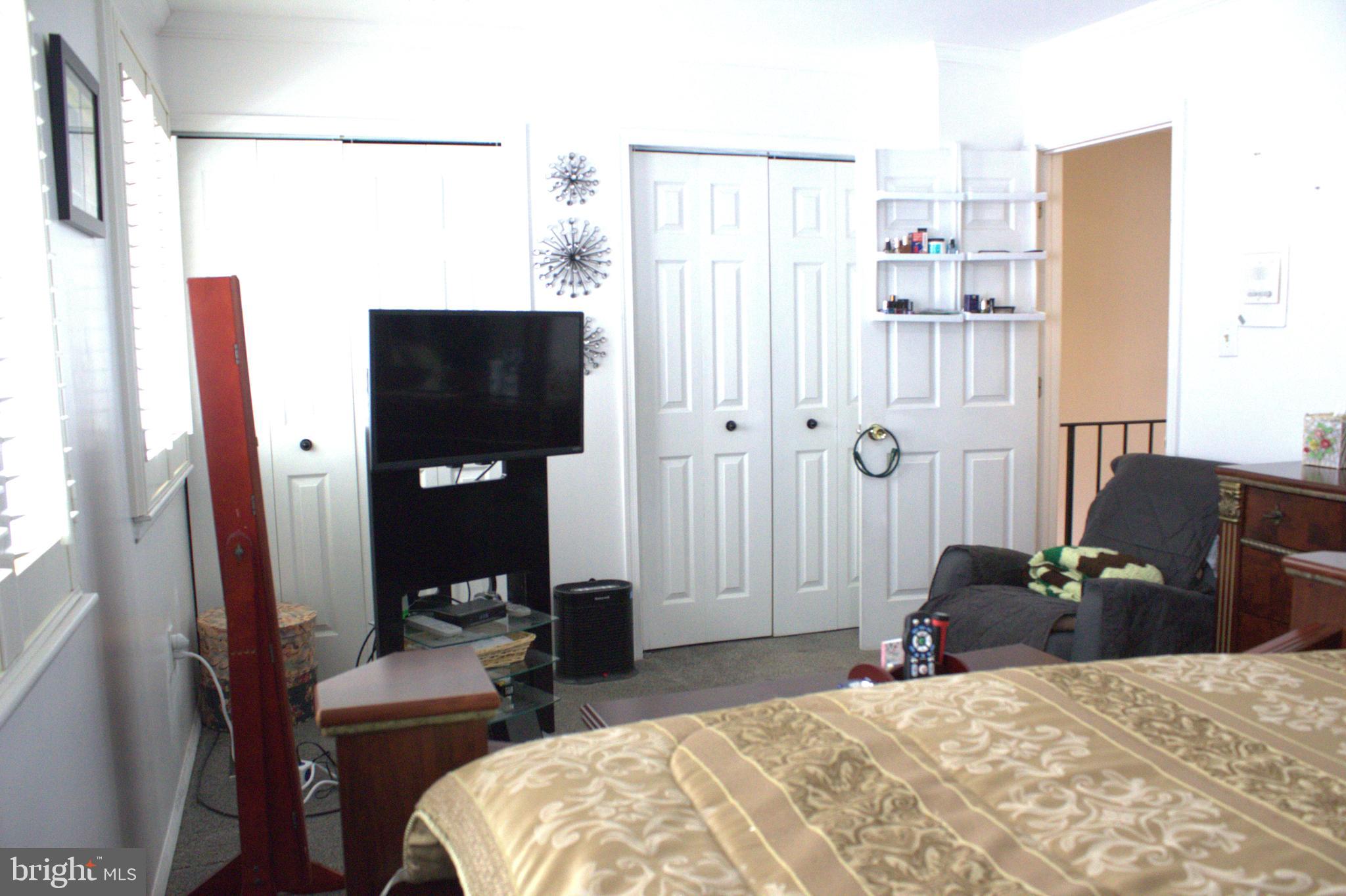 1902 Valley Terrace Southeast Washington, DC 20032 - Photo 16 of 33 a bedroom with a bed a mirror and dresser