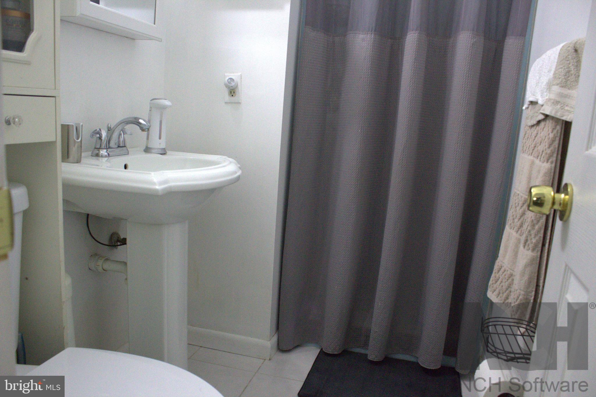 1902 Valley Terrace Southeast Washington, DC 20032 - Photo 17 of 33 a bathroom with sink and mirror