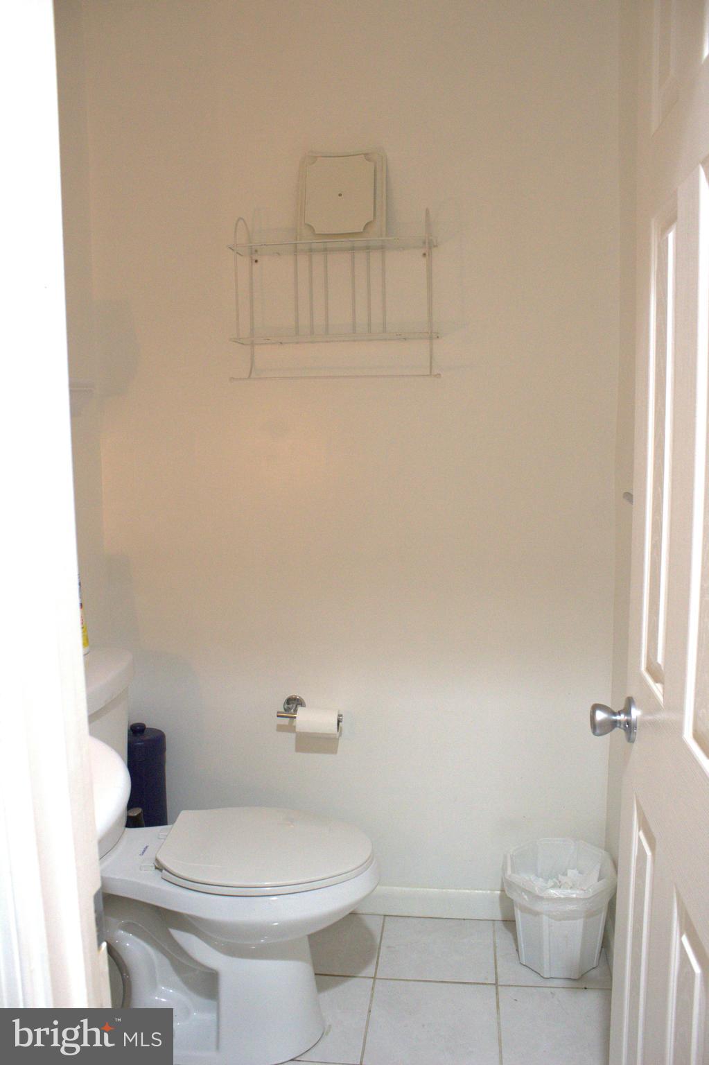 1902 Valley Terrace Southeast Washington, DC 20032 - Photo 21 of 33 a white toilet sitting next to a bathroom sink