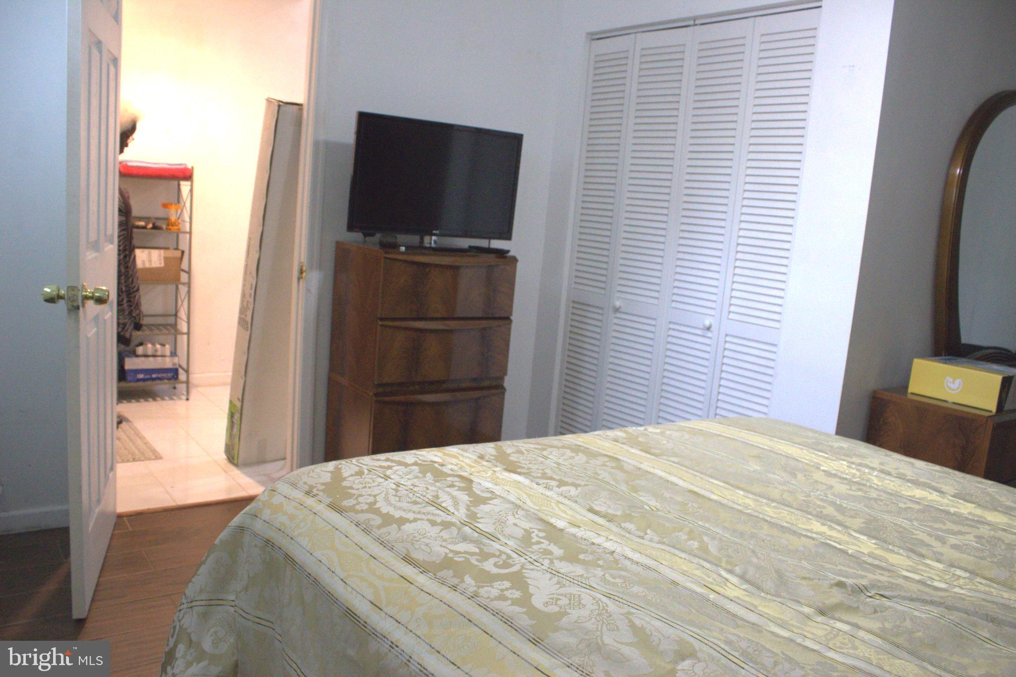 1902 Valley Terrace Southeast Washington, DC 20032 - Photo 23 of 33 a bedroom with a bed and a flat screen tv