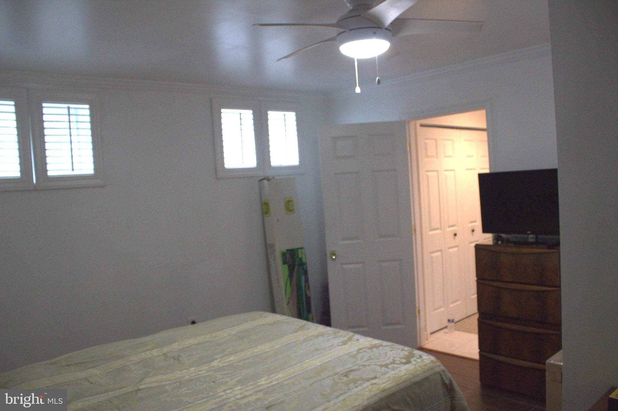 1902 Valley Terrace Southeast Washington, DC 20032 - Photo 24 of 33 a bedroom with a bed and a chandelier