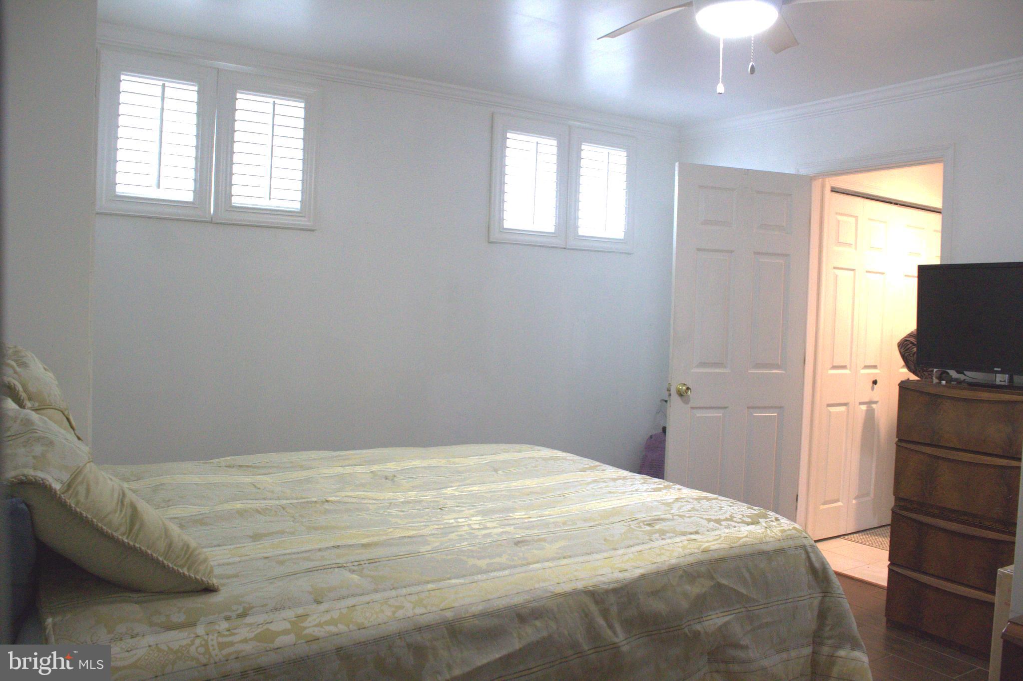 1902 Valley Terrace Southeast Washington, DC 20032 - Photo 25 of 33 a bedroom with a bed and a tv