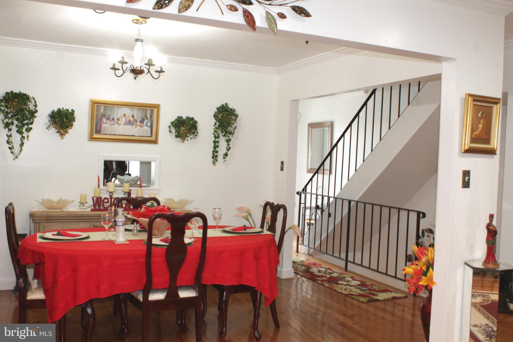 1902 Valley Terrace Southeast Washington, DC 20032 - Photo 6 of 33 a view of a dining room with furniture a chandelier and wooden floor
