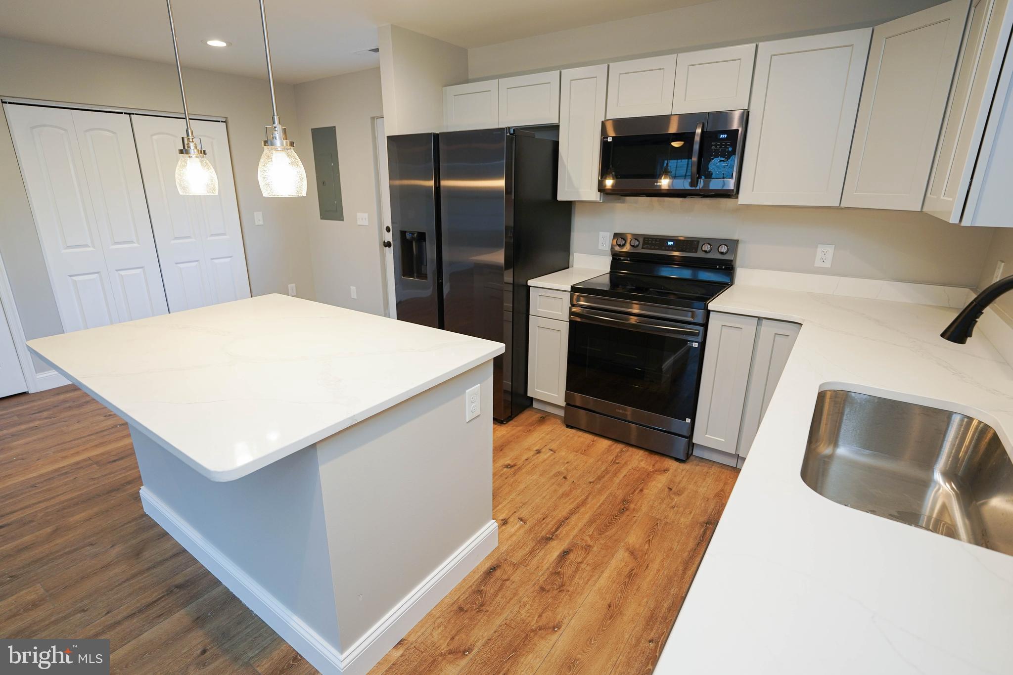 4206 Jacksonville Road Crisfield, MD 21817 - Photo 11 of 34 a kitchen with stainless steel appliances a refrigerator sink and microwave