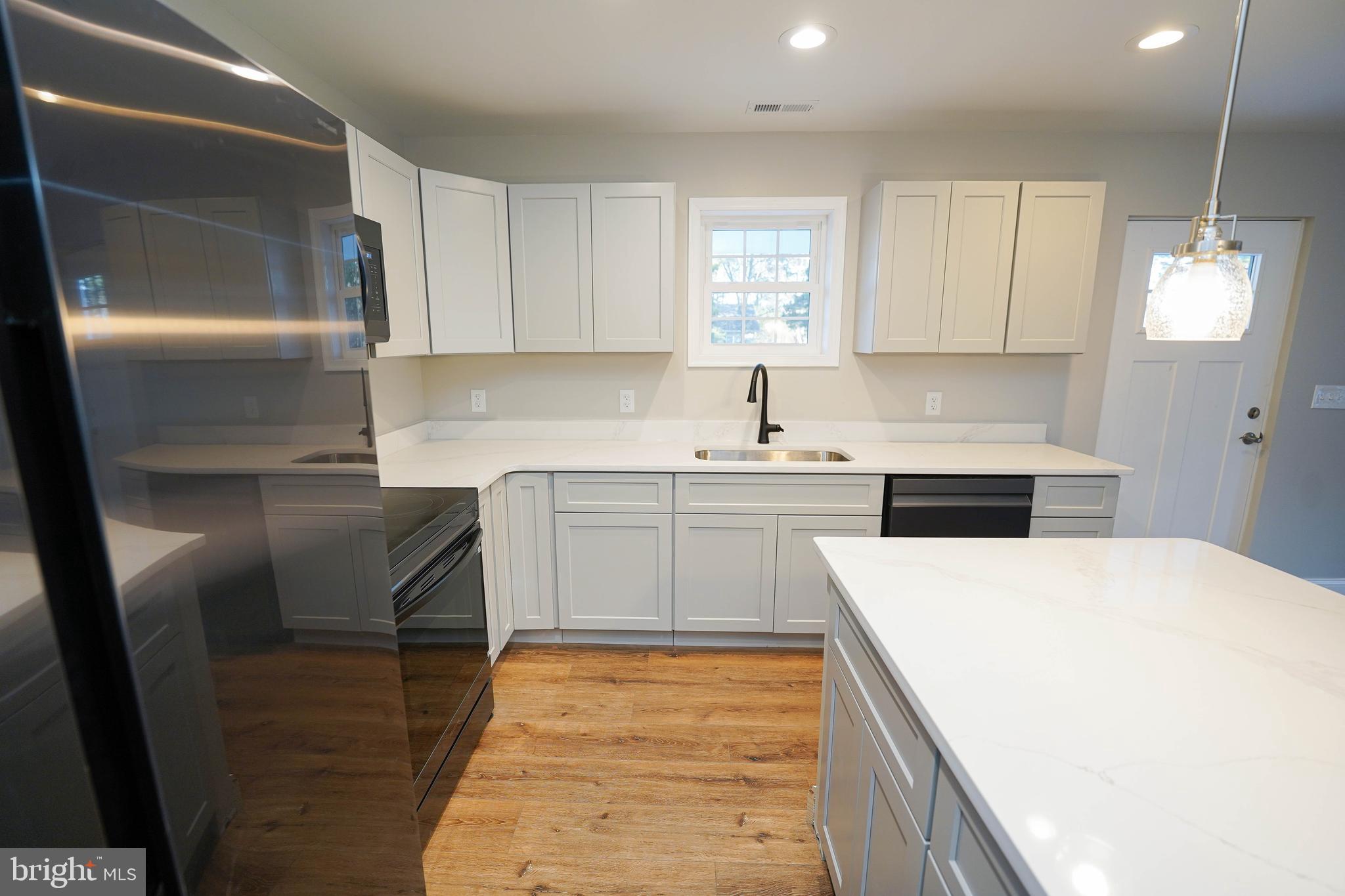 4206 Jacksonville Road Crisfield, MD 21817 - Photo 12 of 34 a kitchen with a sink a refrigerator and window