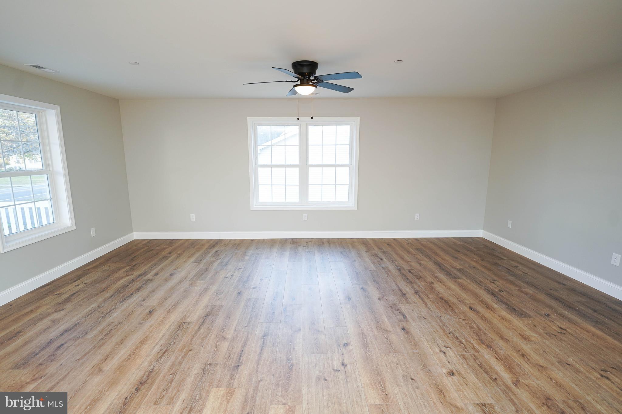 4206 Jacksonville Road Crisfield, MD 21817 - Photo 18 of 34 an empty room with wooden floor and windows