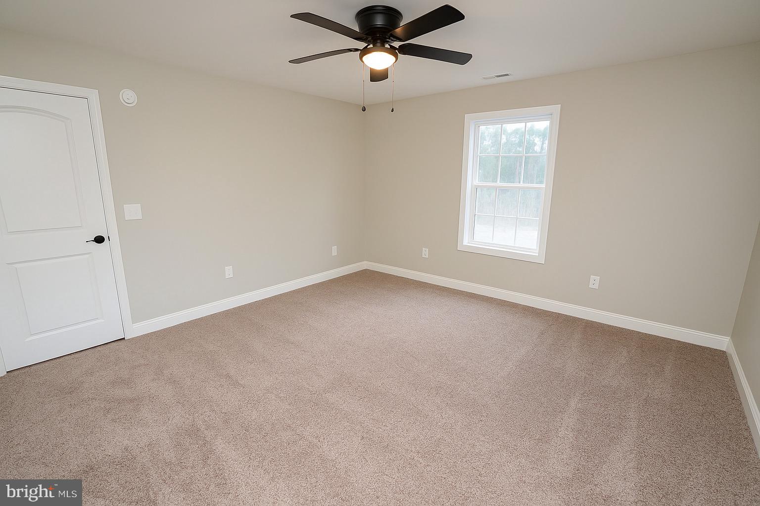 4206 Jacksonville Road Crisfield, MD 21817 - Photo 27 of 34 an empty room with a window and a fan