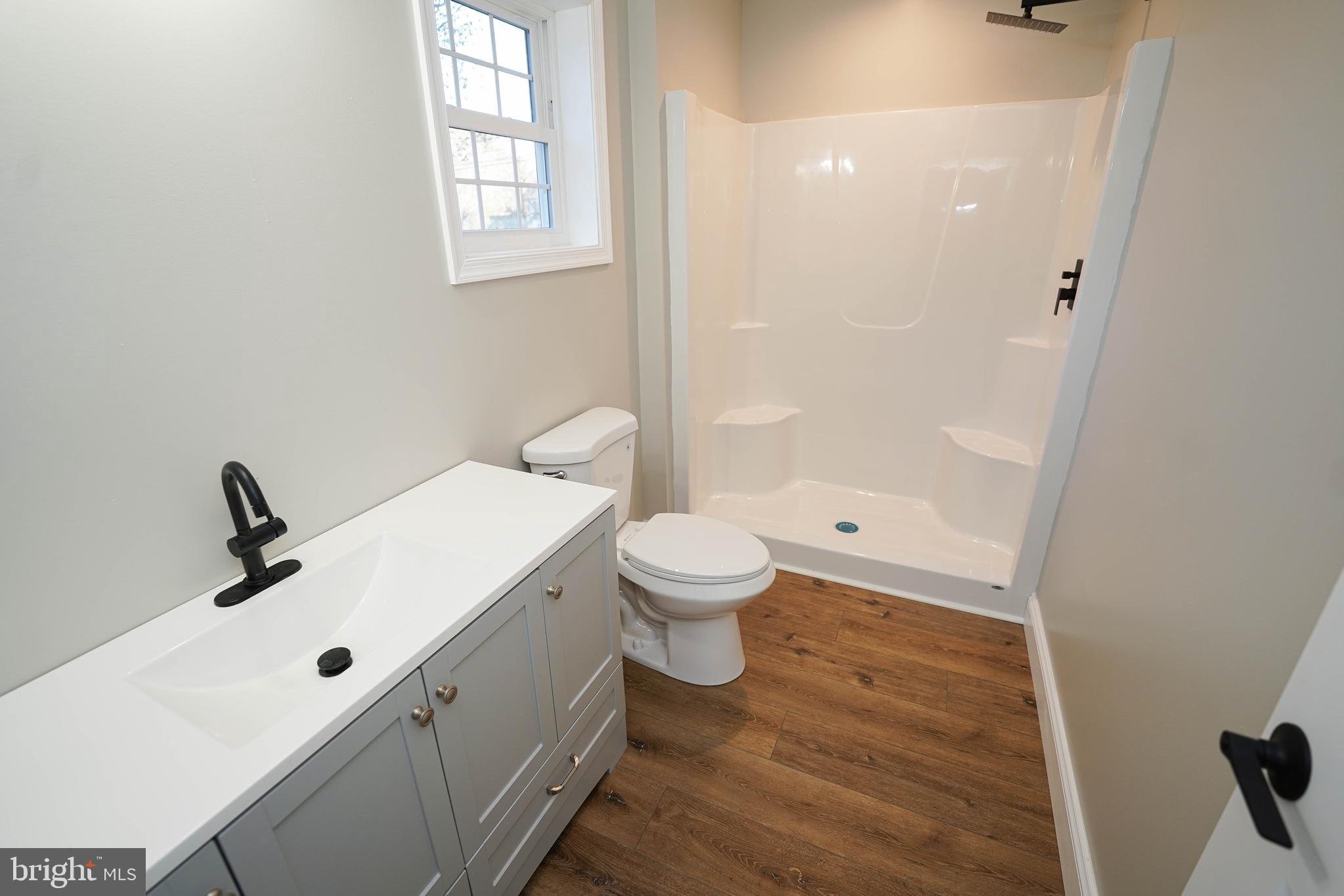 4206 Jacksonville Road Crisfield, MD 21817 - Photo 29 of 34 a bathroom with a sink a toilet and shower