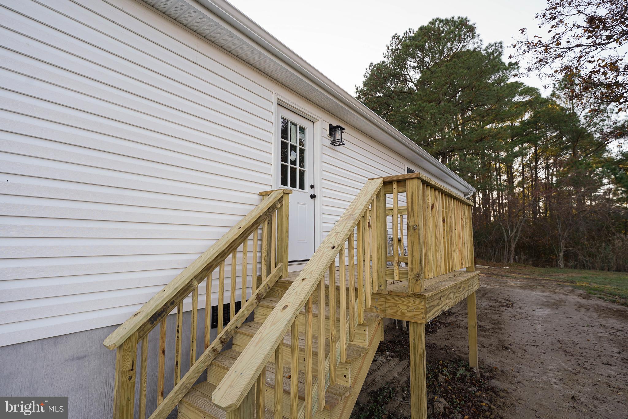 4206 Jacksonville Road Crisfield, MD 21817 - Photo 34 of 34 a front view of a house with wooden stairs