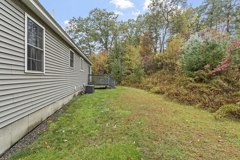 82 Littleton Road Ayer, MA 01432 - Photo 14 of 14 a backyard of a house with lots of green space