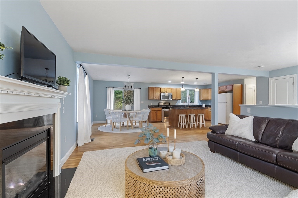 82 Littleton Road Ayer, MA 01432 - Photo 2 of 14 a living room with furniture a fireplace and a flat screen tv