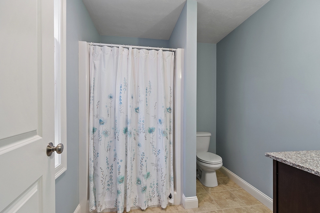 82 Littleton Road Ayer, MA 01432 - Photo 5 of 14 a bathroom with a granite countertop toilet and a sink