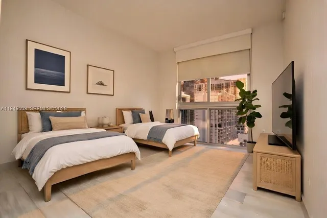 a spacious bedroom with two beds and a couch