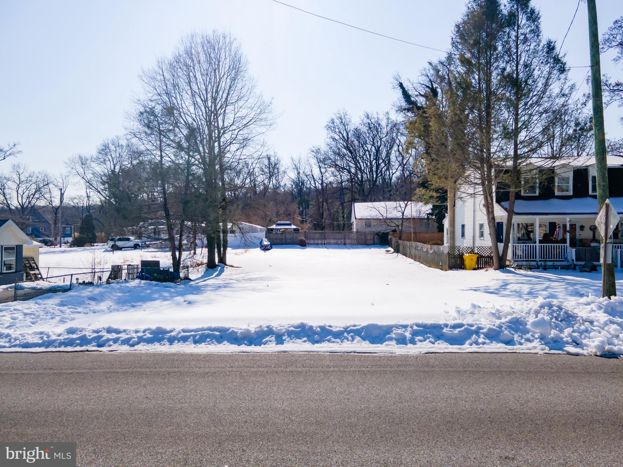 1933 Arundel Road Pasadena, MD 21122 - Photo 2 of 28 a white house that has a tree on the side of the road