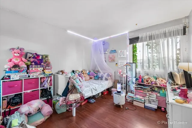a bedroom with furniture and a wooden floor