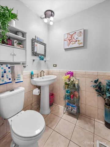 a bathroom with a sink toilet and a mirror