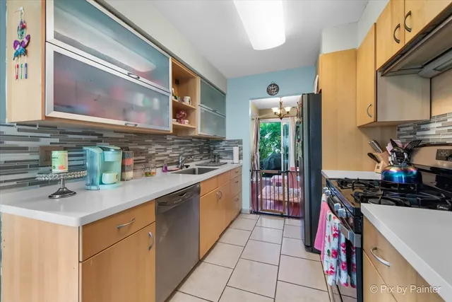 a kitchen with stainless steel appliances a sink stove and cabinets