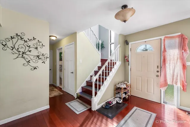 a view of entryway with stairs and wooden floor