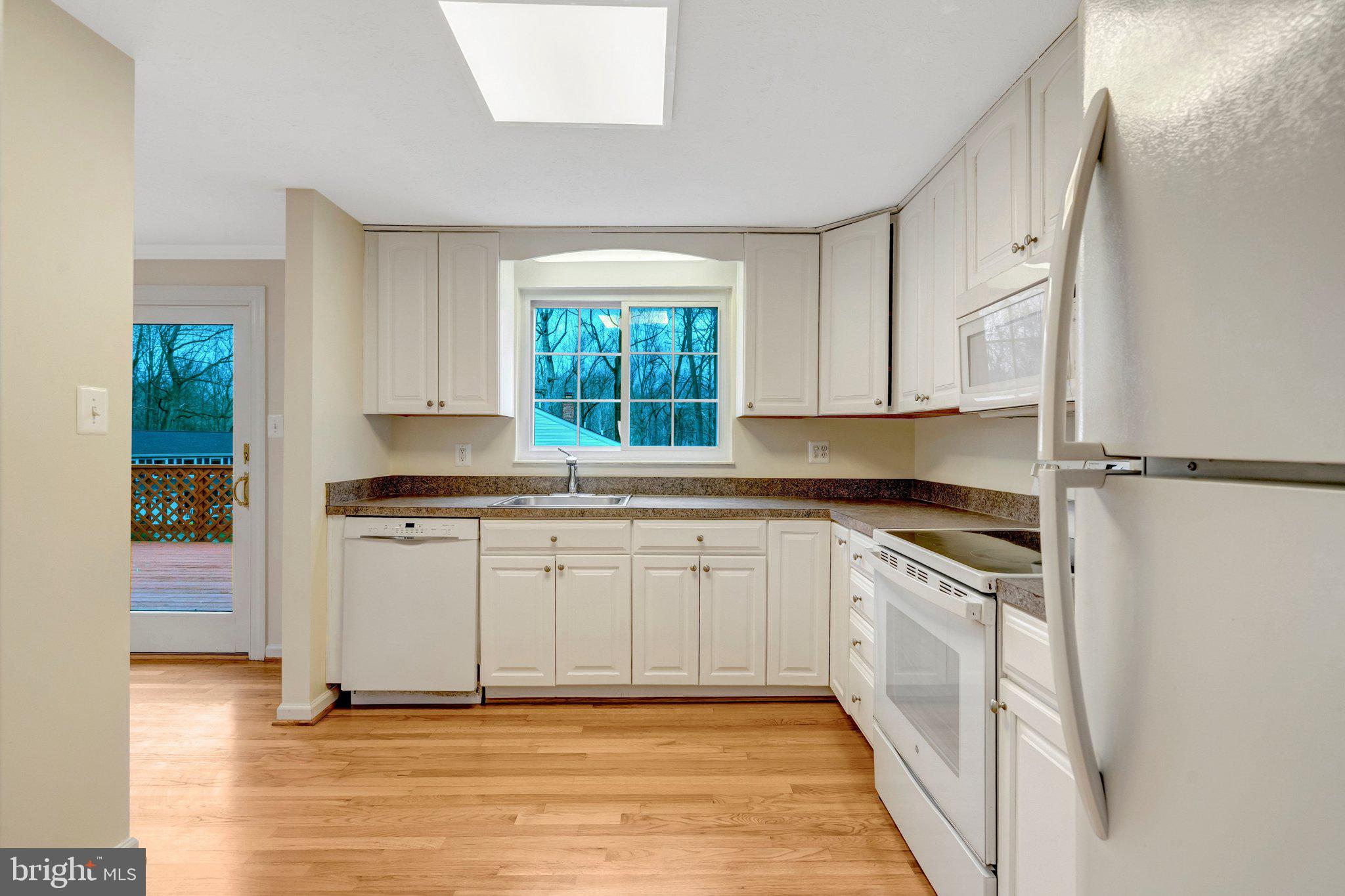 7743 Middle Valley Drive Springfield, VA 22153 - Photo 3 of 17 a kitchen with stainless steel appliances granite countertop a stove a sink and a refrigerator